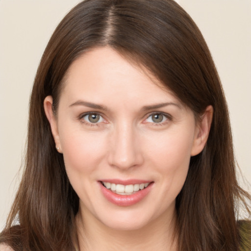 Joyful white young-adult female with long  brown hair and brown eyes