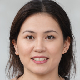 Joyful white young-adult female with medium  brown hair and brown eyes