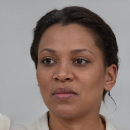 Joyful black adult female with short  brown hair and brown eyes