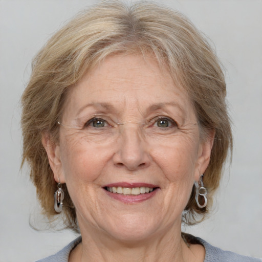 Joyful white middle-aged female with medium  blond hair and blue eyes