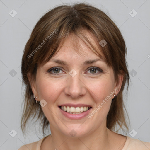 Joyful white adult female with medium  brown hair and grey eyes