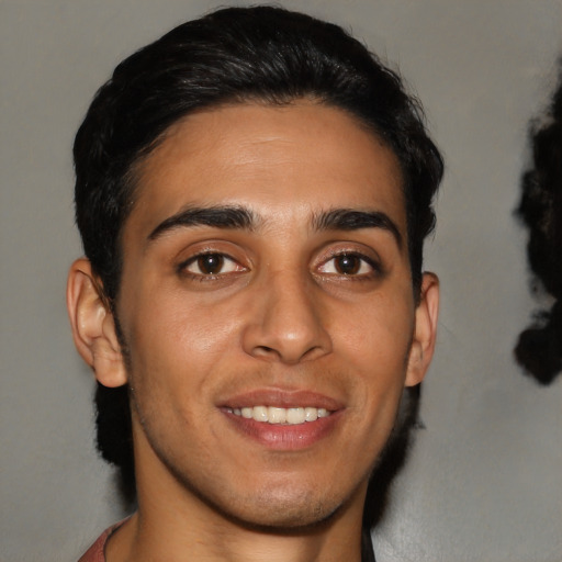 Joyful latino young-adult male with short  brown hair and brown eyes