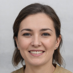 Joyful white young-adult female with medium  brown hair and brown eyes