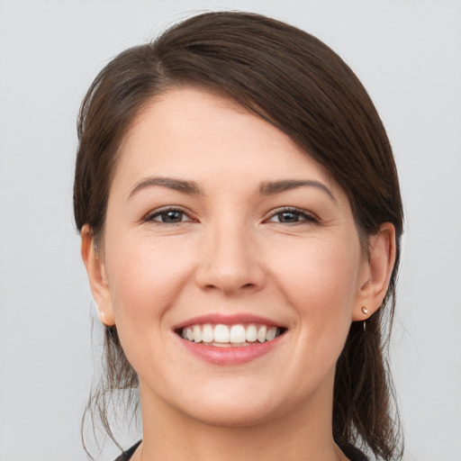 Joyful white young-adult female with medium  brown hair and brown eyes