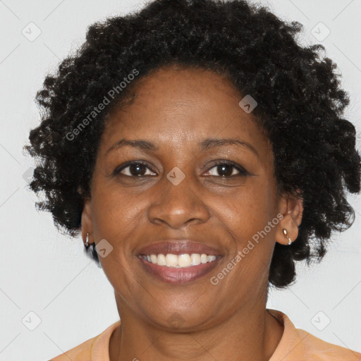 Joyful black adult female with short  brown hair and brown eyes