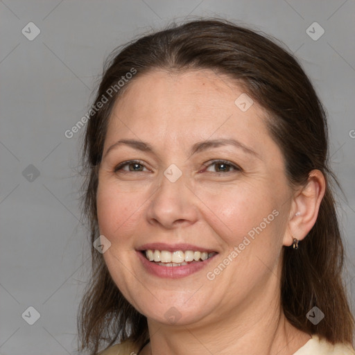 Joyful white adult female with medium  brown hair and brown eyes