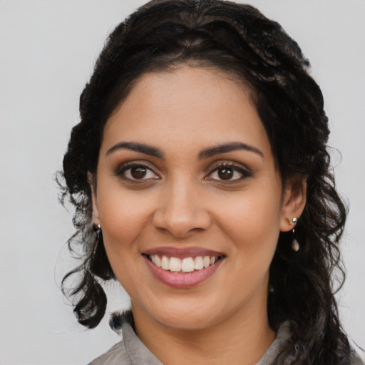 Joyful latino young-adult female with long  brown hair and brown eyes