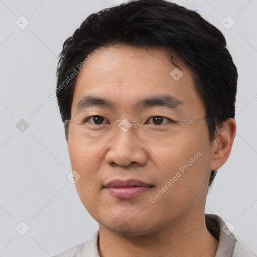 Joyful asian young-adult male with short  brown hair and brown eyes