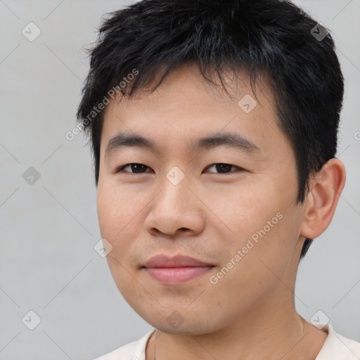 Joyful asian young-adult male with short  black hair and brown eyes