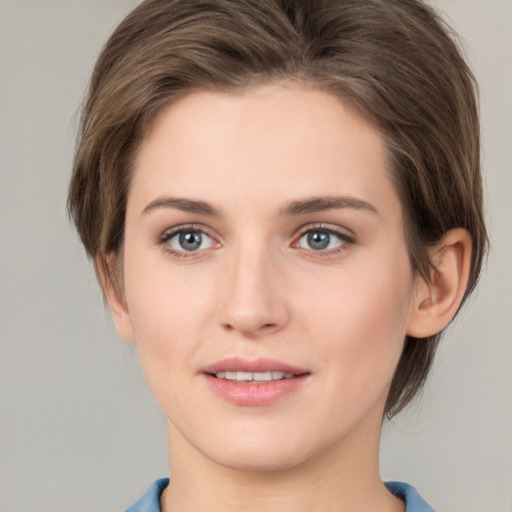 Joyful white young-adult female with medium  brown hair and green eyes