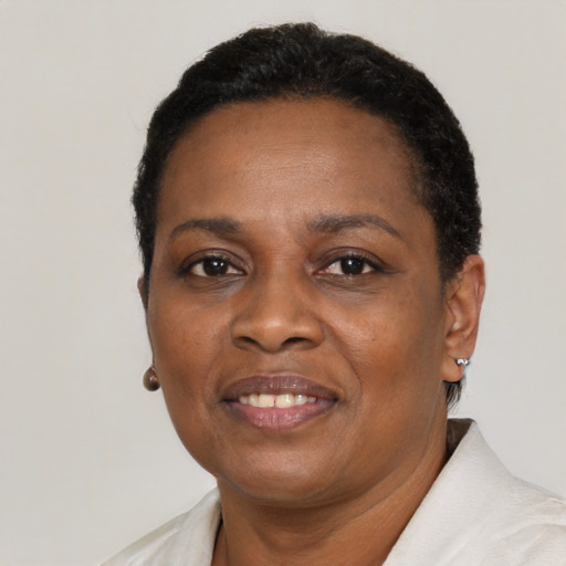 Joyful black adult female with short  black hair and brown eyes