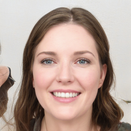 Joyful white young-adult female with long  brown hair and grey eyes