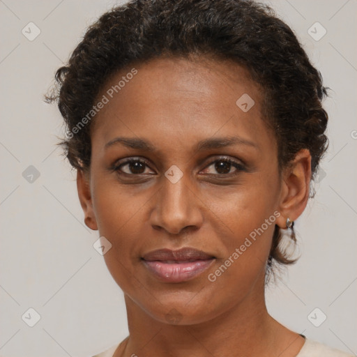 Joyful black young-adult female with short  brown hair and brown eyes
