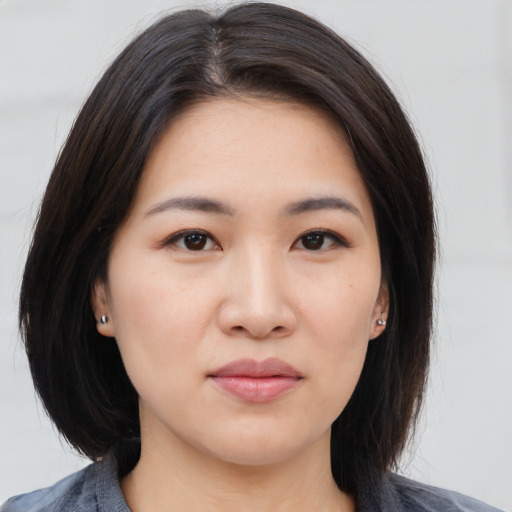 Neutral asian young-adult female with medium  brown hair and brown eyes