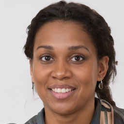 Joyful black adult female with medium  brown hair and brown eyes