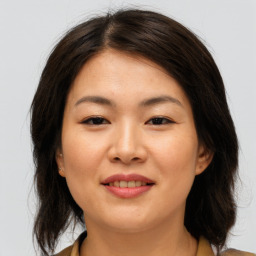 Joyful asian young-adult female with medium  brown hair and brown eyes