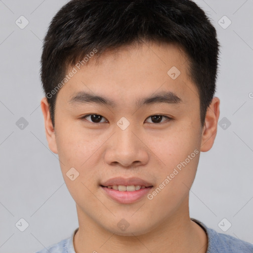 Joyful asian young-adult male with short  brown hair and brown eyes