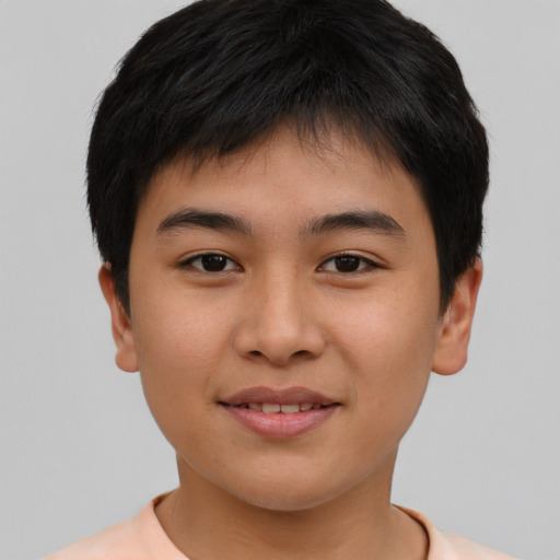 Joyful asian child male with short  brown hair and brown eyes