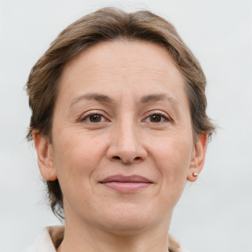 Joyful white adult female with medium  brown hair and brown eyes