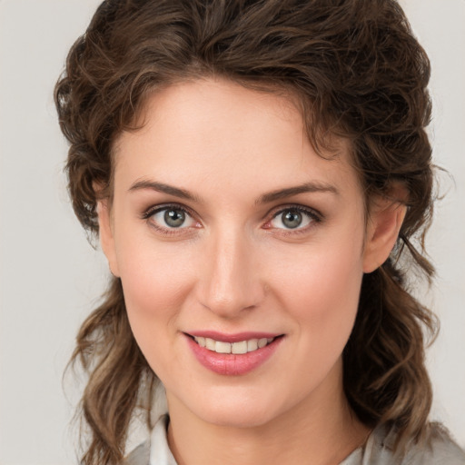 Joyful white young-adult female with medium  brown hair and green eyes