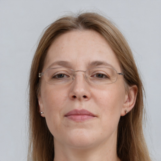 Joyful white adult female with long  brown hair and grey eyes