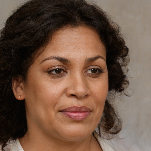 Joyful black adult female with medium  brown hair and brown eyes