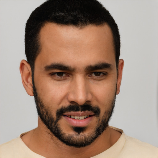 Joyful latino young-adult male with short  black hair and brown eyes