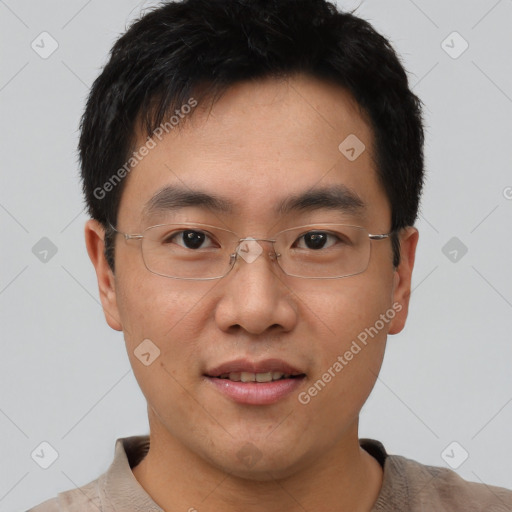 Joyful asian young-adult male with short  black hair and brown eyes