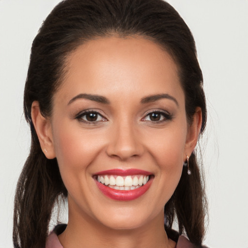 Joyful white young-adult female with long  brown hair and brown eyes