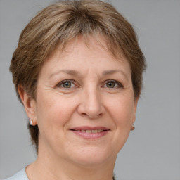 Joyful white adult female with medium  brown hair and brown eyes