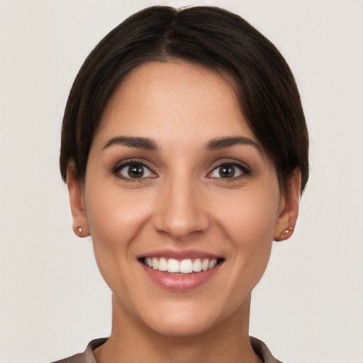 Joyful white young-adult female with short  brown hair and brown eyes