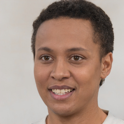 Joyful black young-adult female with short  brown hair and brown eyes