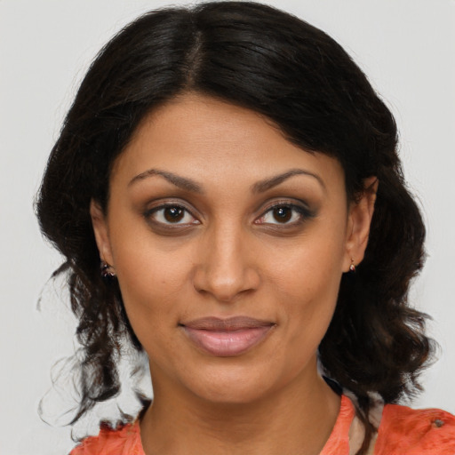 Joyful black young-adult female with medium  brown hair and brown eyes