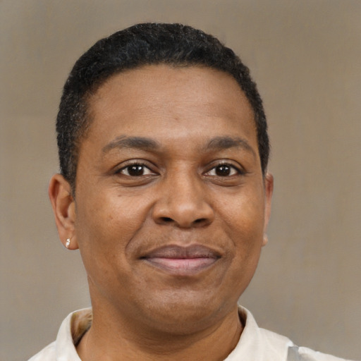 Joyful latino adult male with short  brown hair and brown eyes