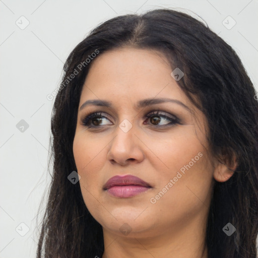 Joyful latino young-adult female with long  brown hair and brown eyes