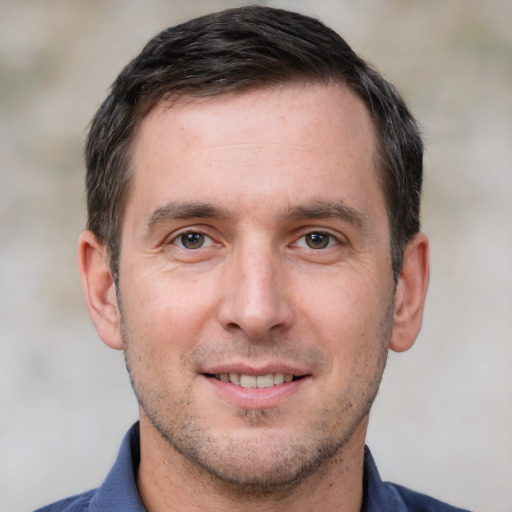 Joyful white adult male with short  brown hair and brown eyes