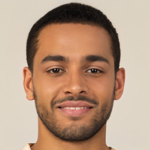 Joyful latino young-adult male with short  brown hair and brown eyes