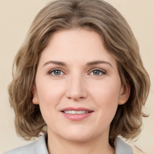 Joyful white young-adult female with medium  brown hair and green eyes