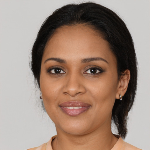 Joyful black young-adult female with medium  black hair and brown eyes