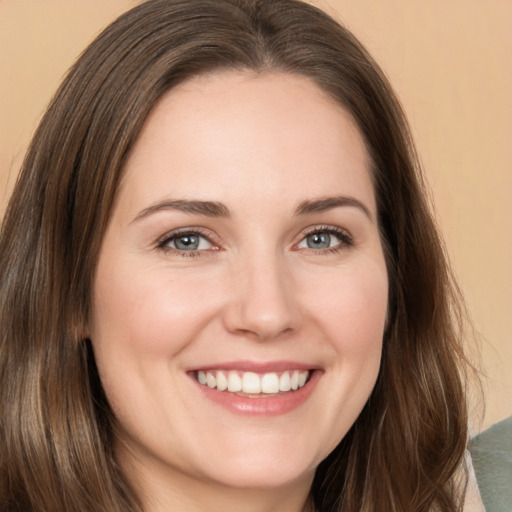 Joyful white young-adult female with long  brown hair and brown eyes