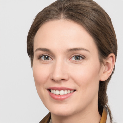 Joyful white young-adult female with medium  brown hair and grey eyes