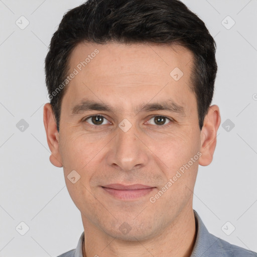 Joyful white young-adult male with short  black hair and brown eyes