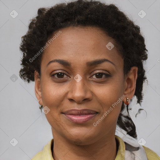 Joyful black adult female with short  brown hair and brown eyes