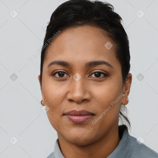 Joyful latino young-adult female with short  black hair and brown eyes