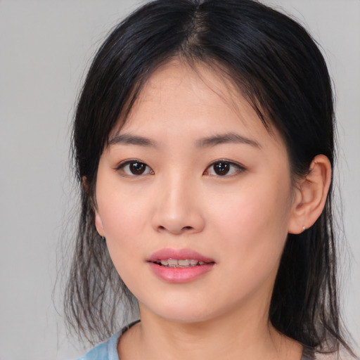 Joyful asian young-adult female with medium  black hair and brown eyes