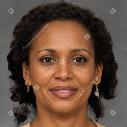 Joyful black adult female with medium  brown hair and brown eyes