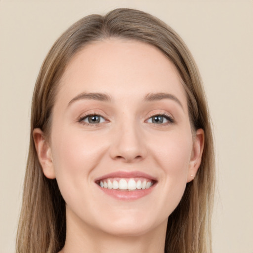 Joyful white young-adult female with long  brown hair and grey eyes