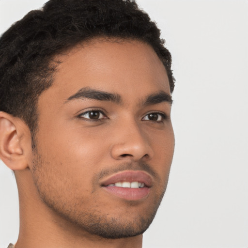 Joyful latino young-adult male with short  brown hair and brown eyes