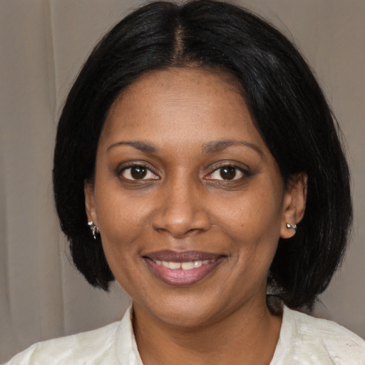 Joyful black young-adult female with medium  black hair and brown eyes