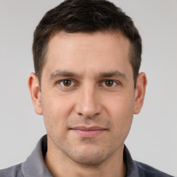 Joyful white young-adult male with short  brown hair and brown eyes